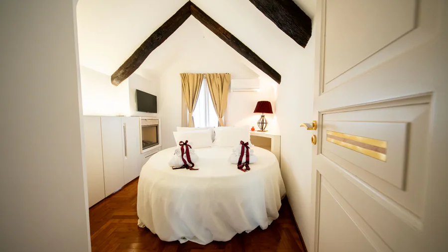 Camera romantica con letto rotondo e fiocchi rossi nella Suite San Martino a Martina Franca